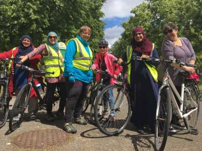 Photo of group of women standing next to their bikes