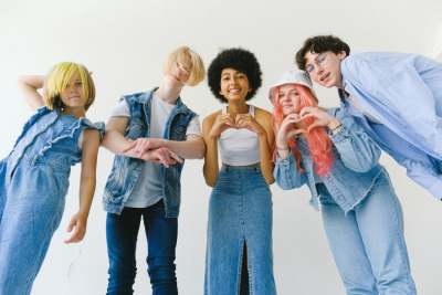 Group of five young people wearing denim clothes