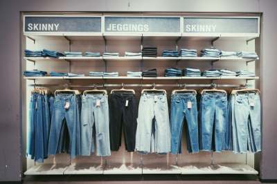 Different types of jeans hanging up in a shop