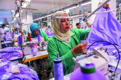 Woman wearing head scarf working in a garment factory