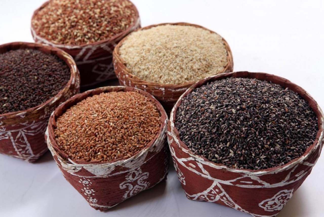Image: different rices in traditionally decorated indian containers