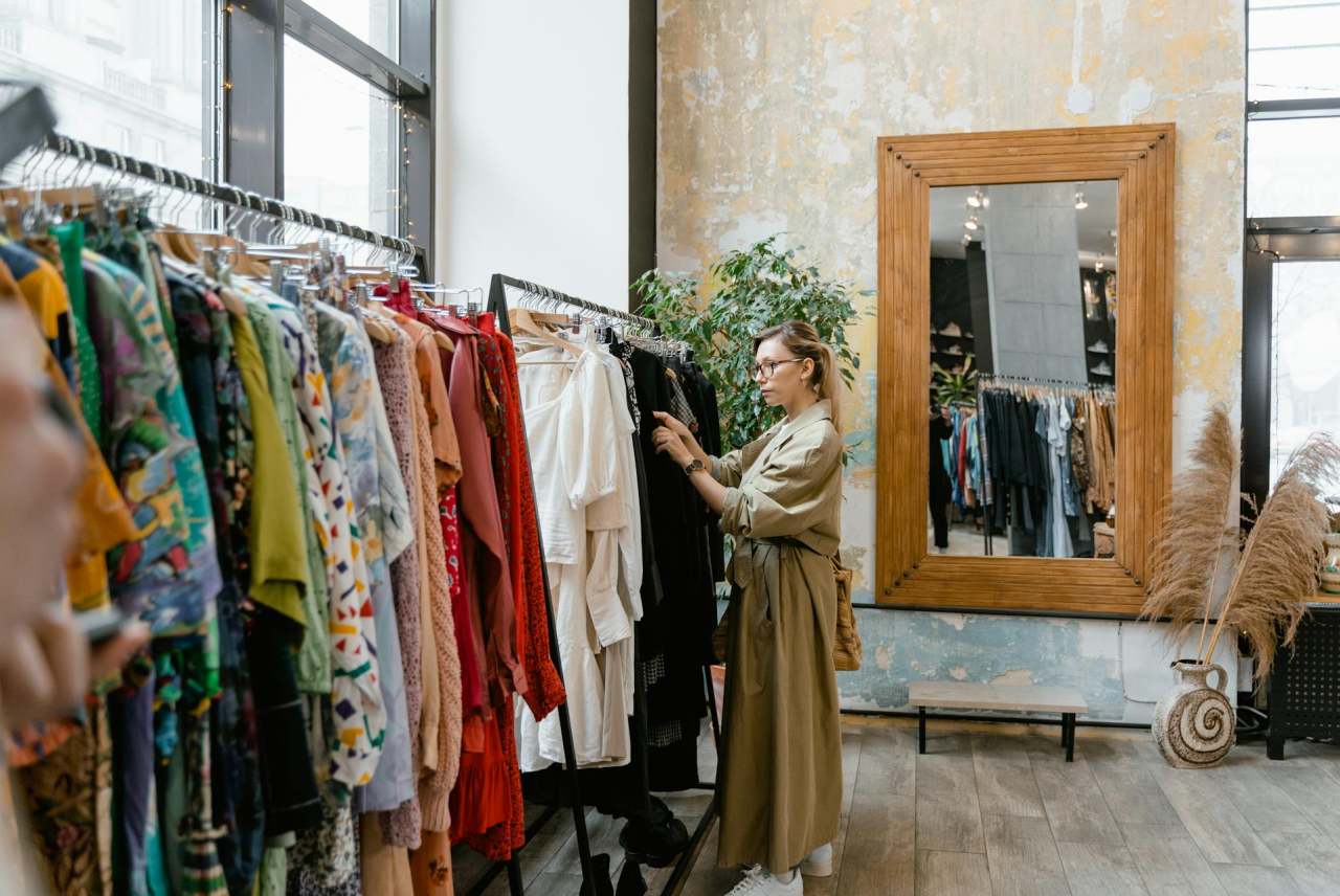 Woman browsing clothing racks in shop