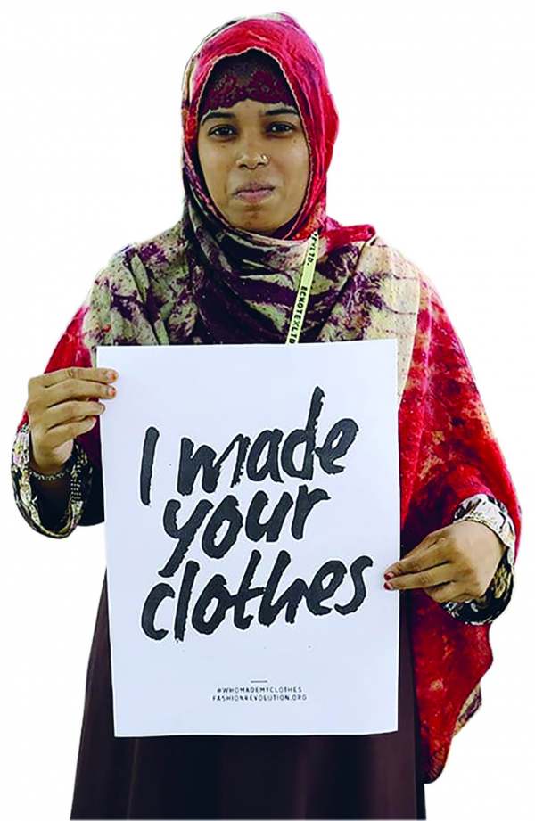 image: lady in sari with sign stating i made your clothes