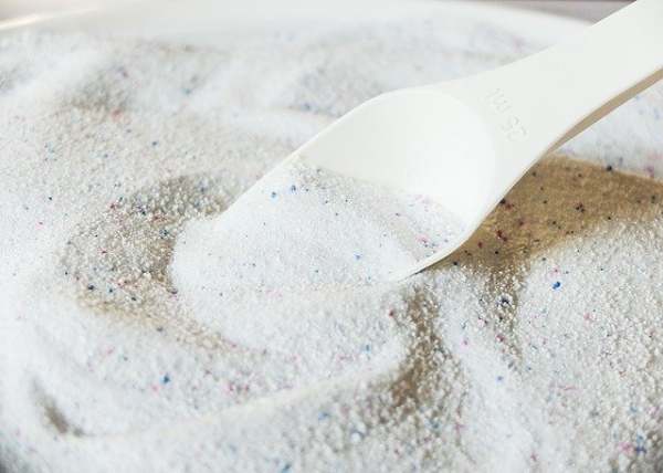 white detergent powder with spoon