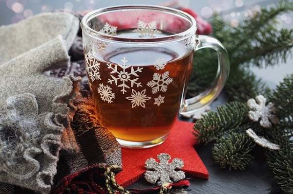 glass mug of tea with christmas decorations