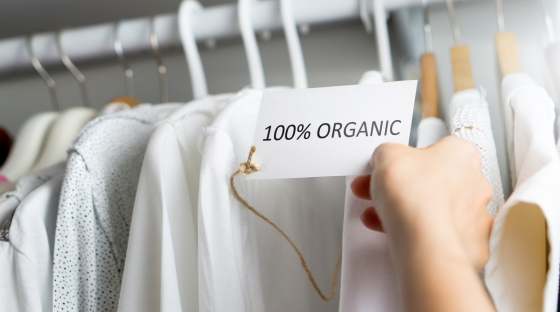 Rack with white clothes and label which says '100% organic'