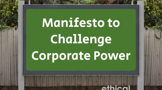Billboard on street with words 'manifesto to challenge corporate power'