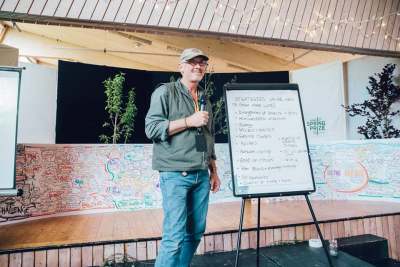 Image: judge lush spring prize standing in front of audience smiling