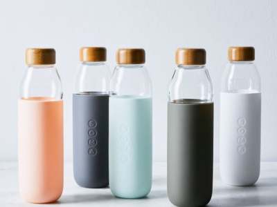 image: selection of glass water bottles in a row different colours 