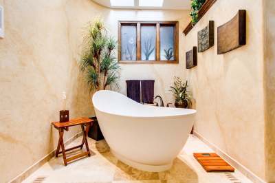 image: ethical bathroom with bowl bath and wooden features eco friendly plants