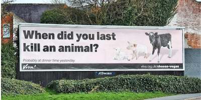 image: billboard with when did you last kill an animal written on it and photo of calf piglet and lamb
