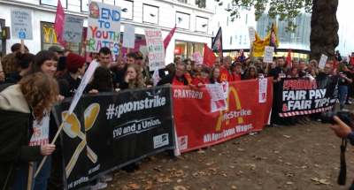 image: strike for fair pay workers holding banners mcdonalds wetherspoons coronavirus pandemic tgi fridays