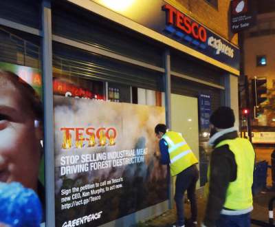 Protesters rebrand the exterior of a Tesco shop to protest about deforestation linked to meat production