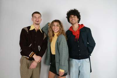 Two men and one woman modelling vintage clothing