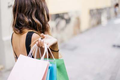 Photo of back of woman carrying shopping bags 