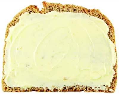 Slice of brown bread with butter spread on top