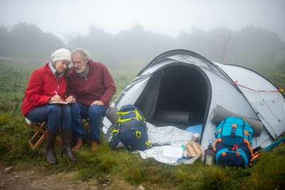 Elderly couple camping outdoors