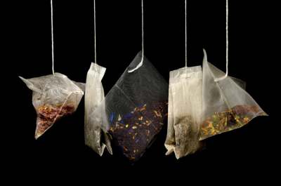 Five different tea bags hanging up by their string