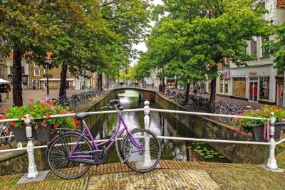 bike leaning against canal bridge