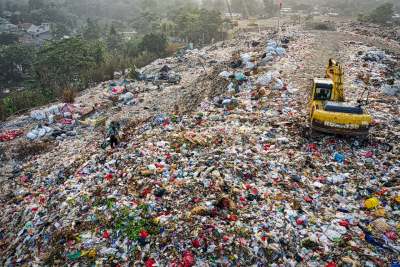 Landfill dump Indonesia with person and digger