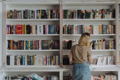 Bookshop shelves with a person browsing the books