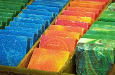 Rows of rectangular unpackaged brightly coloured soap bars