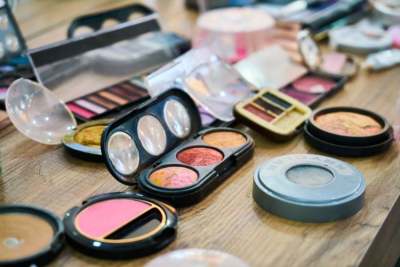 Selection of colourful make up products on table