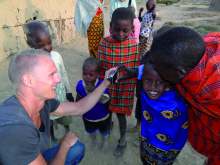 Image: Tourists and children in Kenya due to Into Africa, one of Tourism Concern's approved Ethical Tour Operators