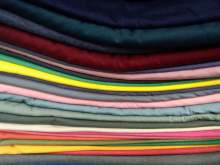 Image: ethical tshirts folded in a pile different colours