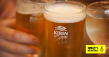 image: kirin beer can in focus in hand brooklyn lager donations burmese military