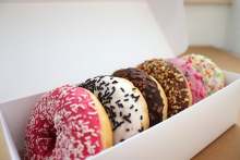 Iced donuts in a white cardboard box