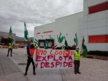 Workers protesting outside warehouse with banner