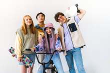 Group of 4 young people modeling clothes