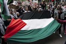 Palestine flag being held by group of people