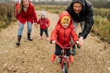 Man and woman with two children all in outdoor clothing in rain