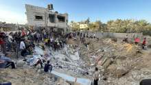 People gathered around rubble of houses in Gaza hit by air strike 