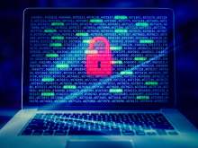 Laptop with numbers code on screen and image of red padlock