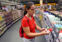 Women in shop comparing two deodorants