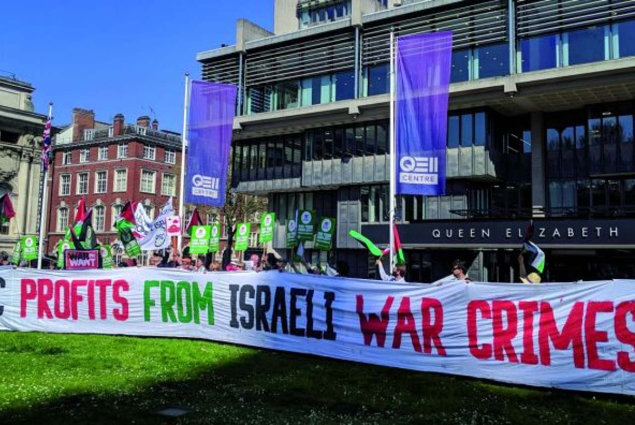 image: protesters with banner reading hsbc profits from israeli war crimes which led to hsbc divesting from israeli war crimes