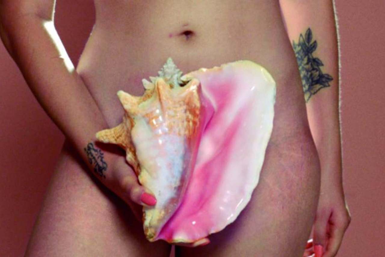 Image: conch shell in front of a vulva lip syncing song