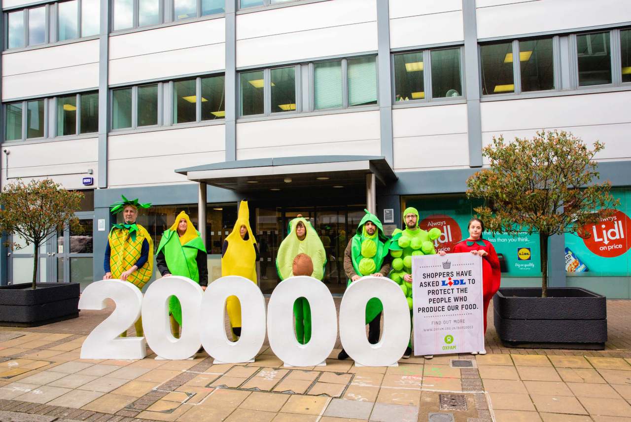 image: oxfam human rights campaign aldi protest 20000 protesters dressed up as fruit and vegetables outside lidl
