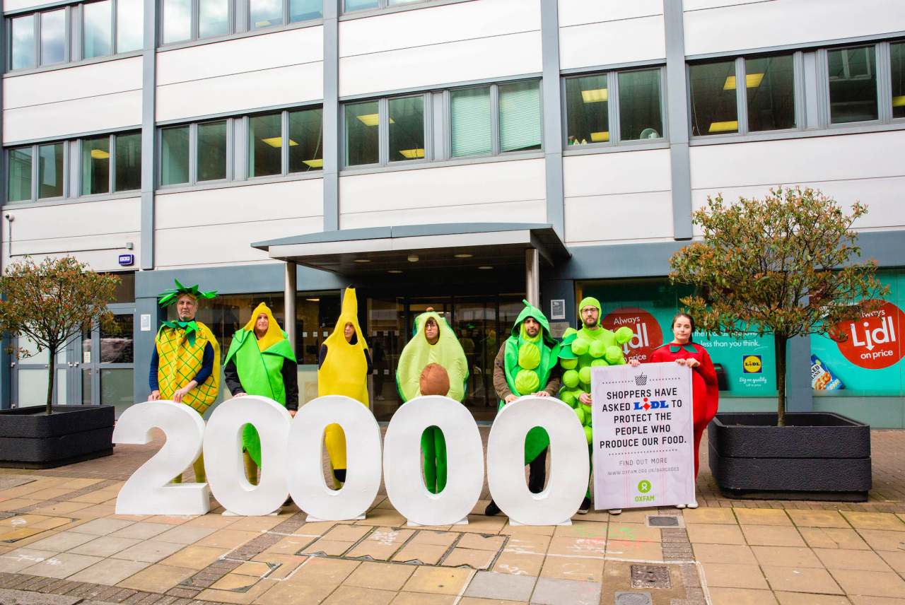 image: oxfam human rights campaign aldi protest 20000 protesters dressed up as fruit and vegetables outside lidl