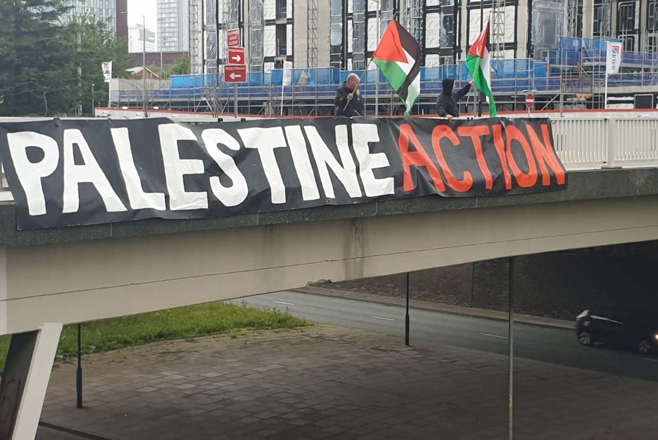 image: palestine action banner across a bridge in the UK