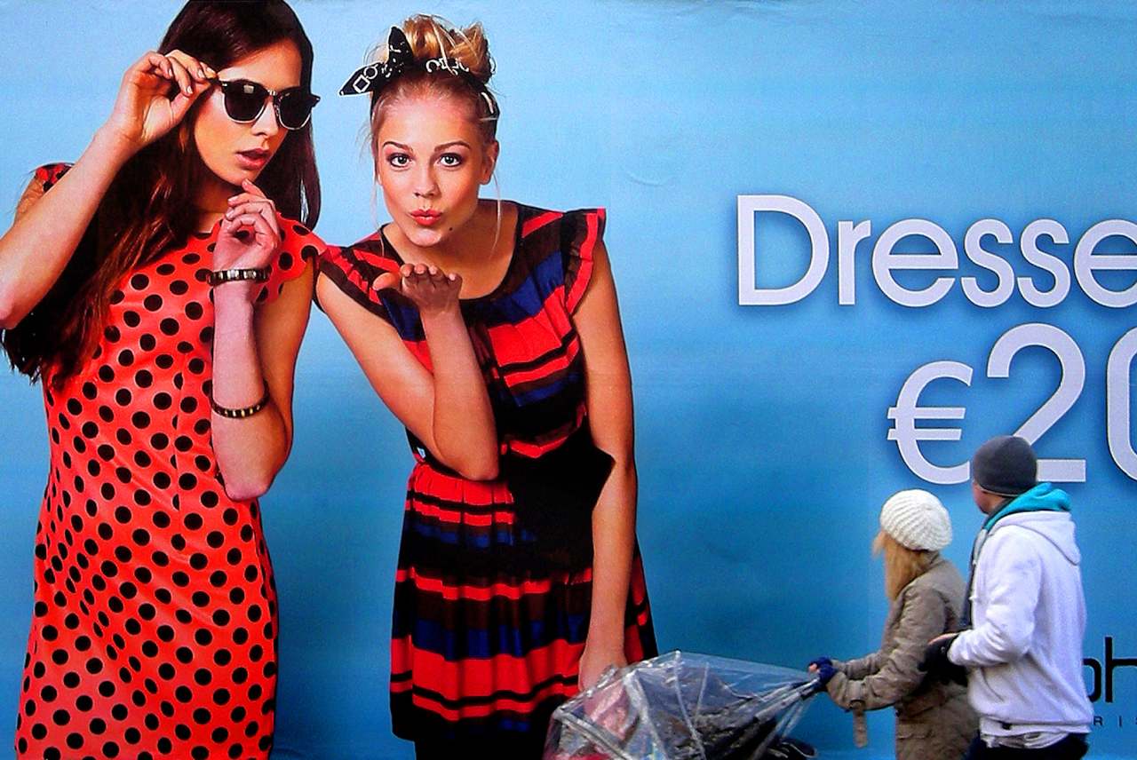 image: boohoo dresses poster people look as they walk past