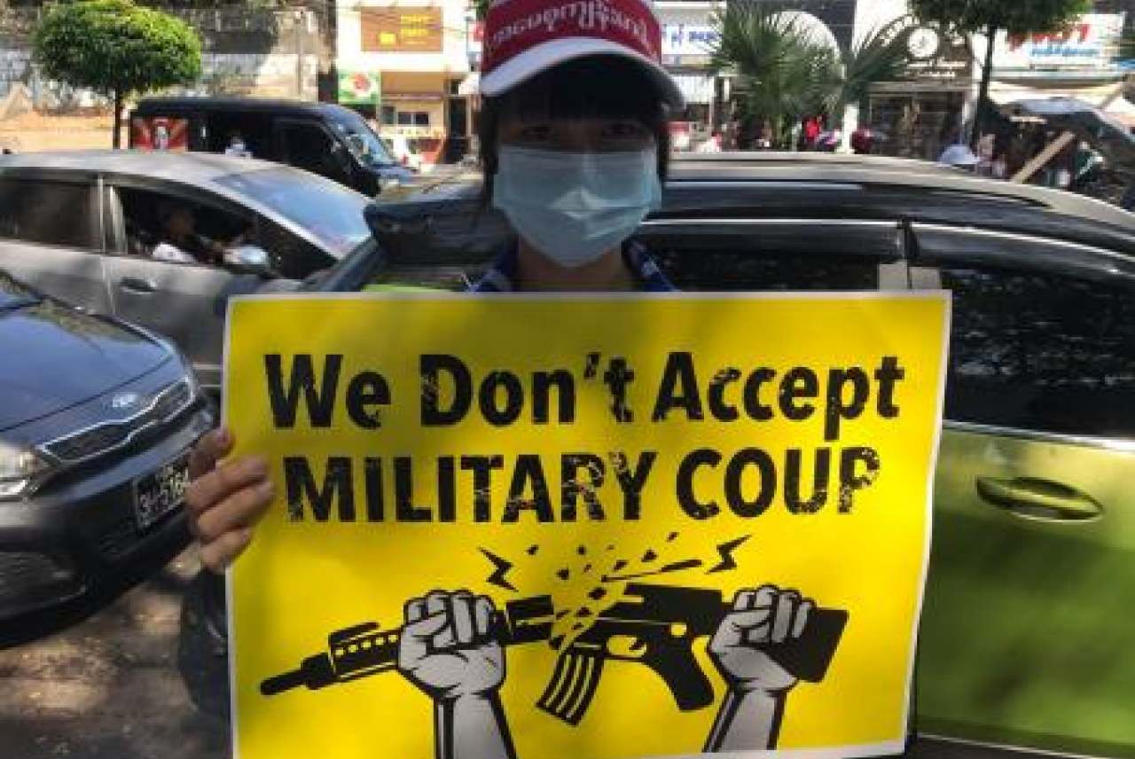 Person holding protest sign about military coup Myanmar