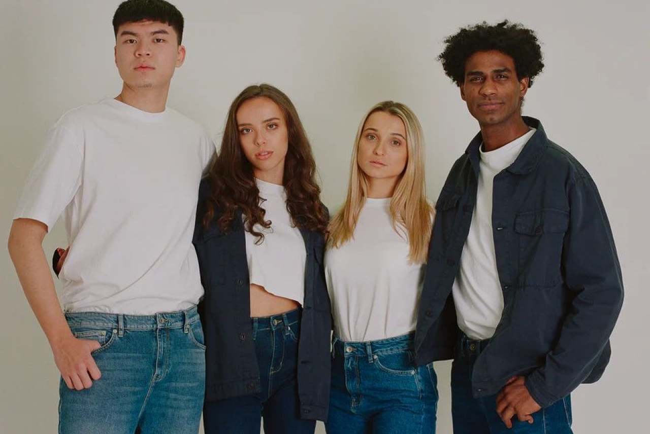 4 people wearing white tshirts and denim jeans