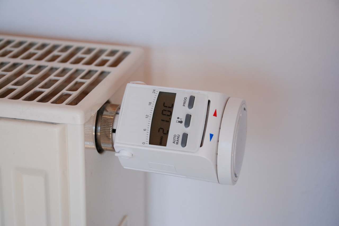 Smart thermostat attached to radiator set to 21 degrees celsius