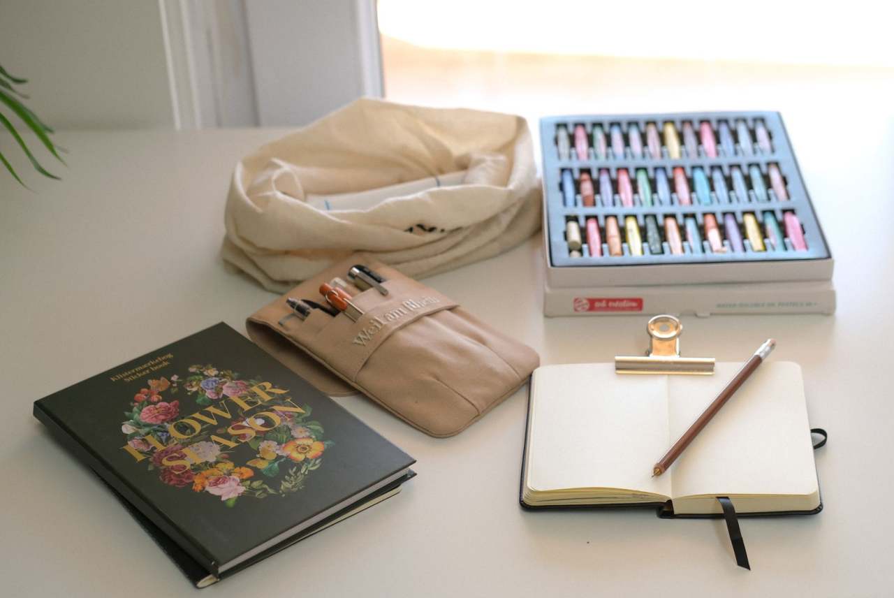 Notepad, pens and stationery on table