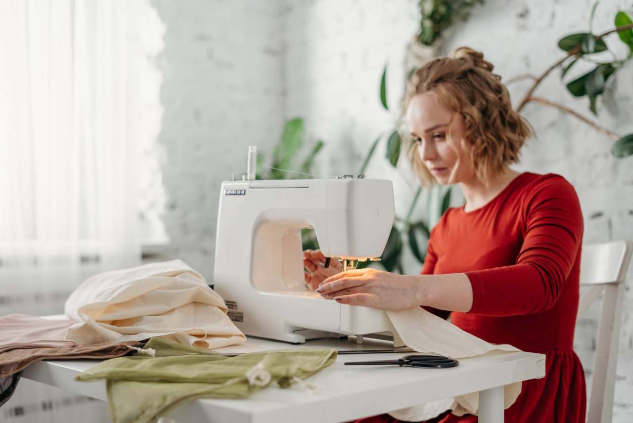Woman using sewing machine to make clothes