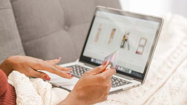 Online shopping on laptop with woman holding credit card